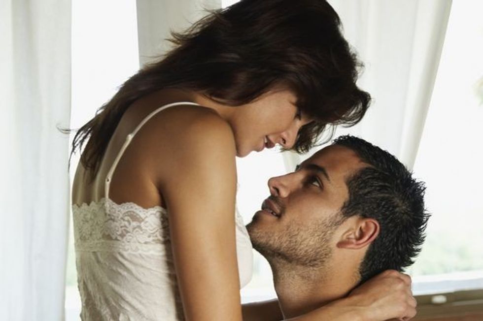 Couple hugging in bedroom