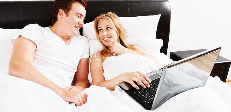 Couple in bed with laptop
