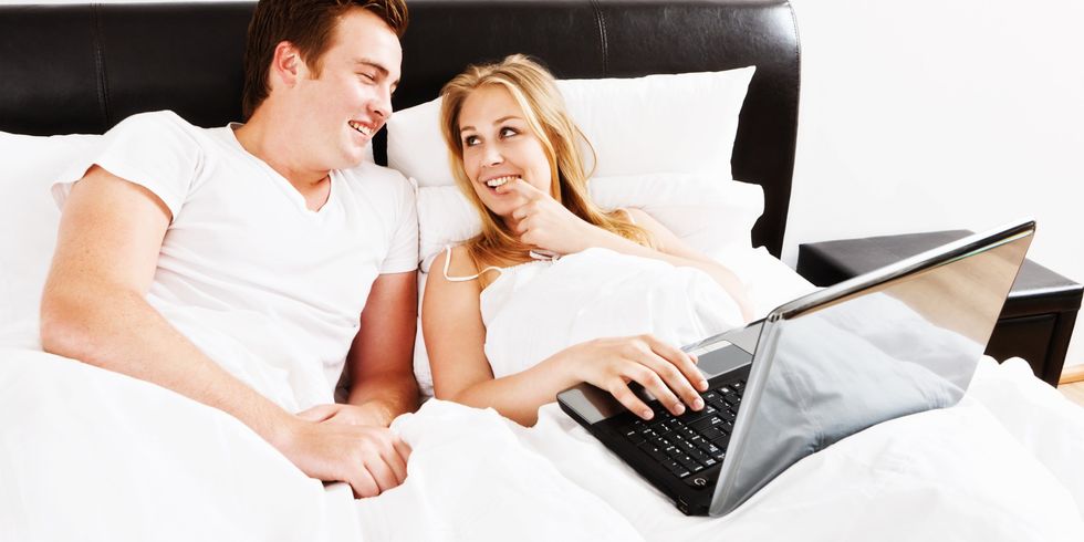 Couple in bed with laptop