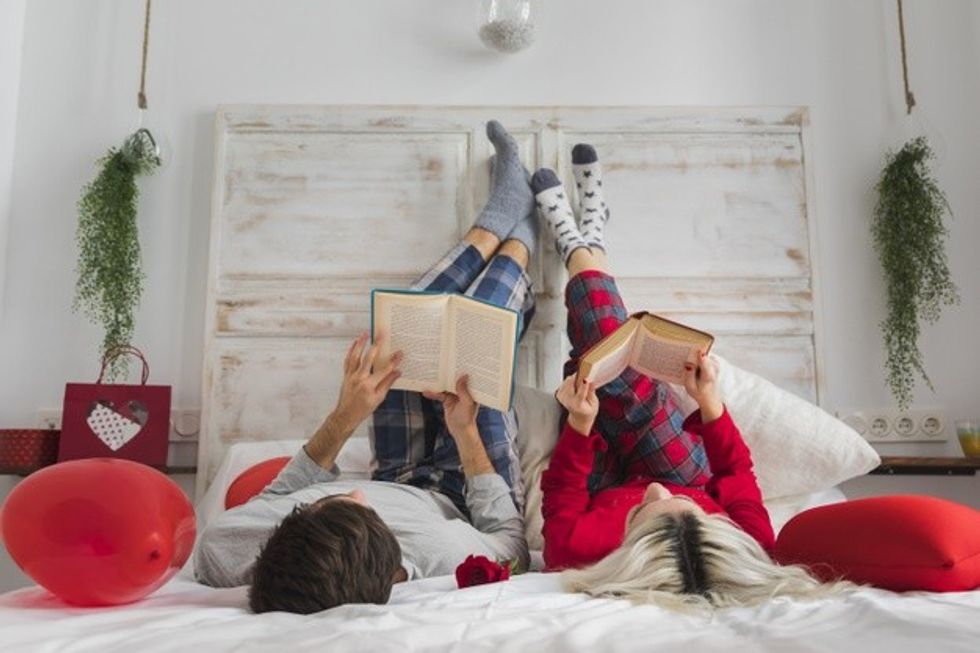 couple reading bed valentines day 23 2148383149