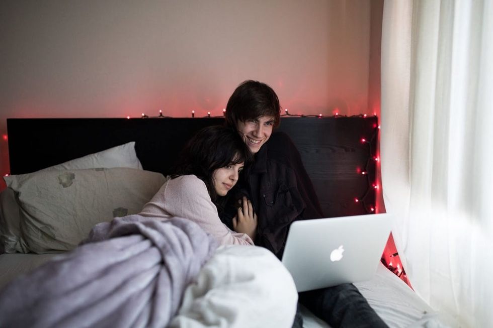 couple watching laptop in bed 1
