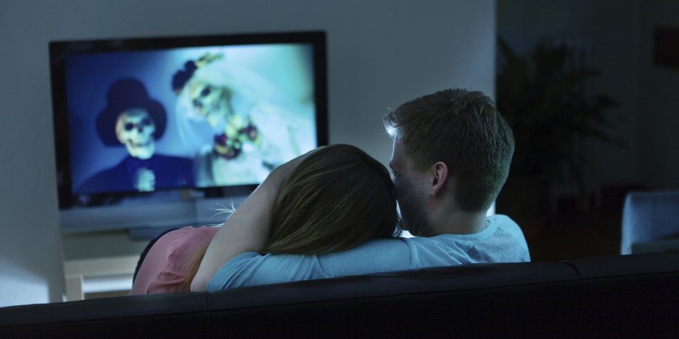 Couple Watching Scary Halloween Movie Together on TV