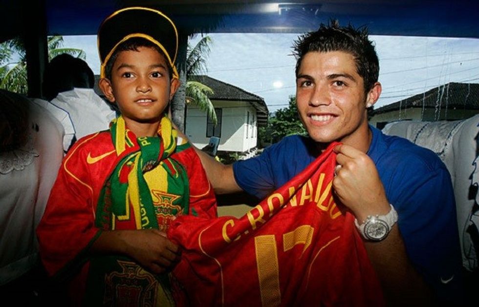 Cristiano Ronaldo with a child who survived the Indonesian tsunami in 2004 football