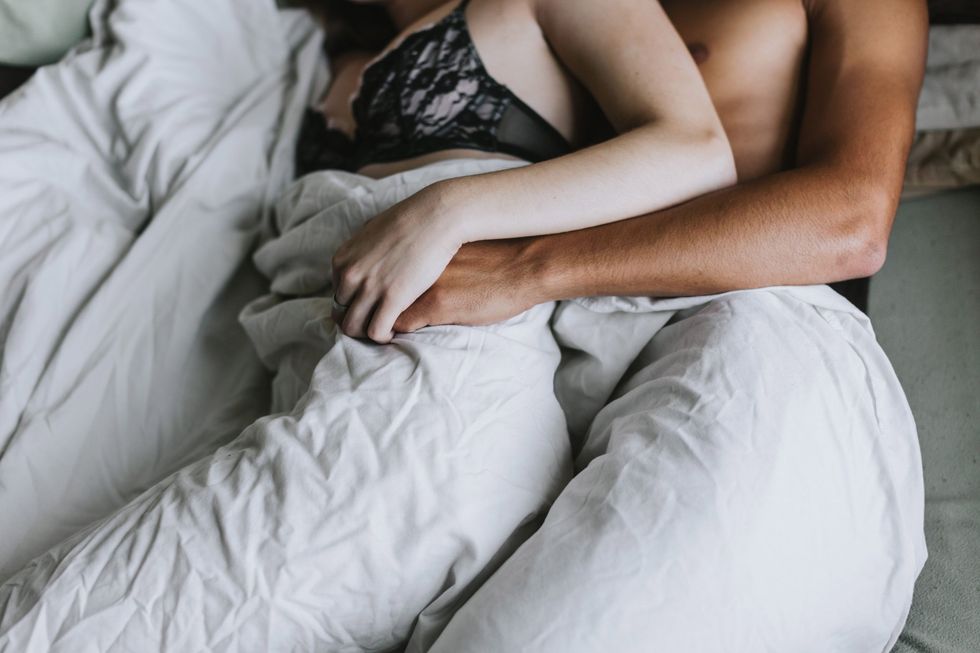 cropped view of couple spooning in bed royalty free image 680787089 1565019538 scaled