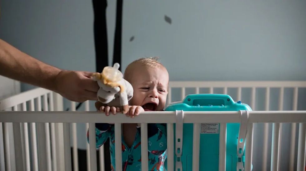 crying baby in crib header