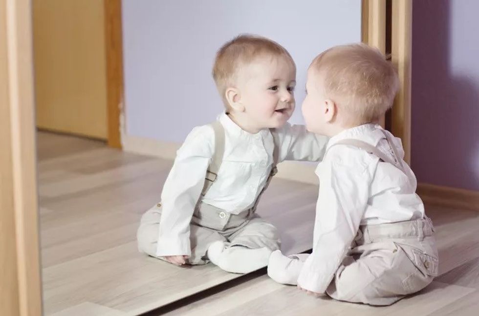 cute baby boy smiling at his reflection 165823085 5b311da843a103003607c2bb