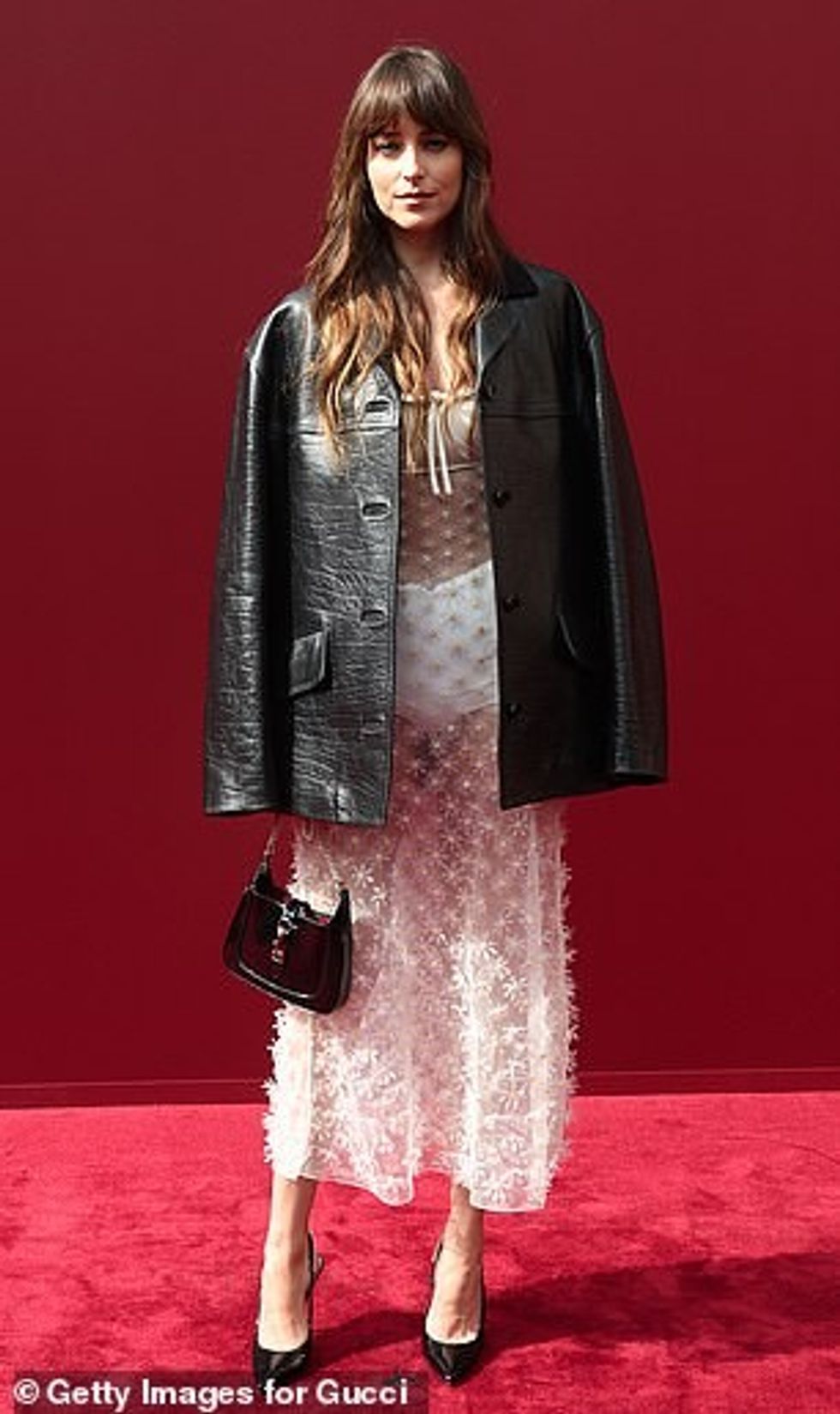 Dakota Johnson set pulses racing in a sheer pink dress as she attended Milan Fashion Week's Gucci show