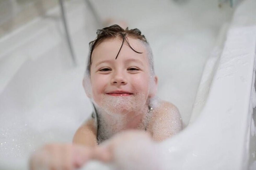 depositphotos 371479428 stock photo little girl playing soap foam