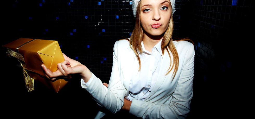 depositphotos 78435498 stock photo unhappy young woman holding gift