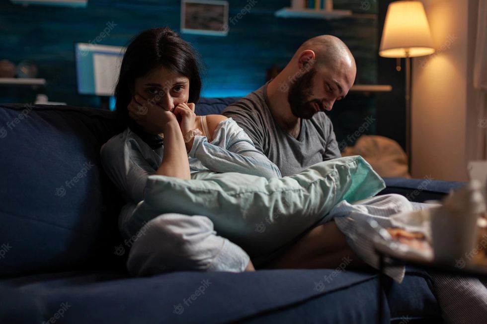 desperate woman with anxiety sitting couch with boyfriend you