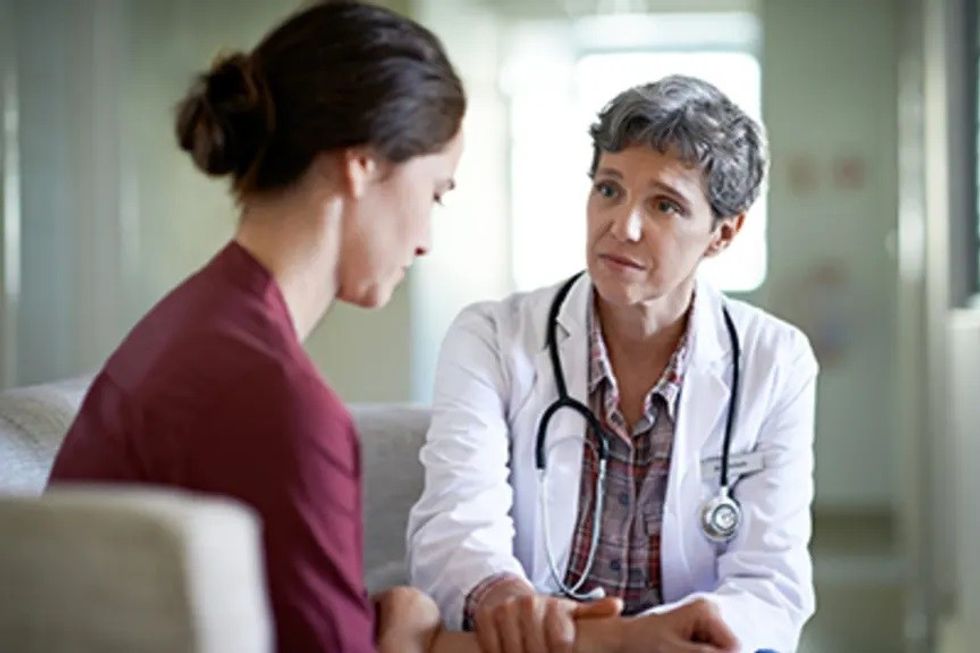 Doctor comforting patient iStock 475780616