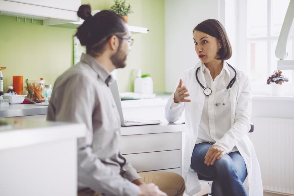 doctor consulting with patient and discussing hiv and cancer