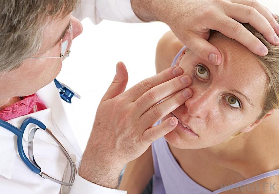 doctor examines womans eye