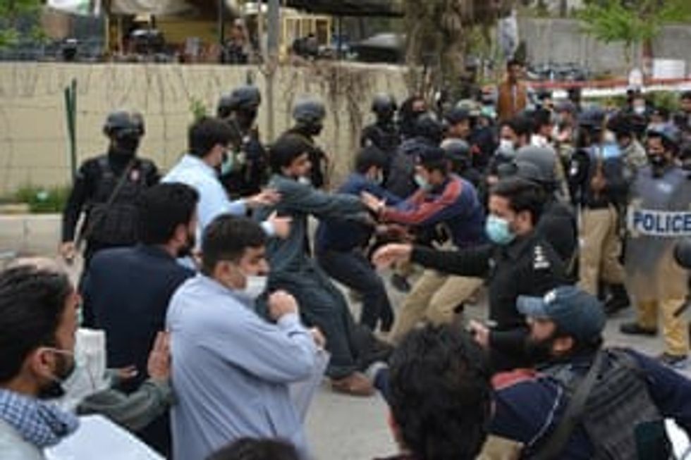 Doctors and paramedics scuffle with policemen as they stage a protest against a lack of safety equipment