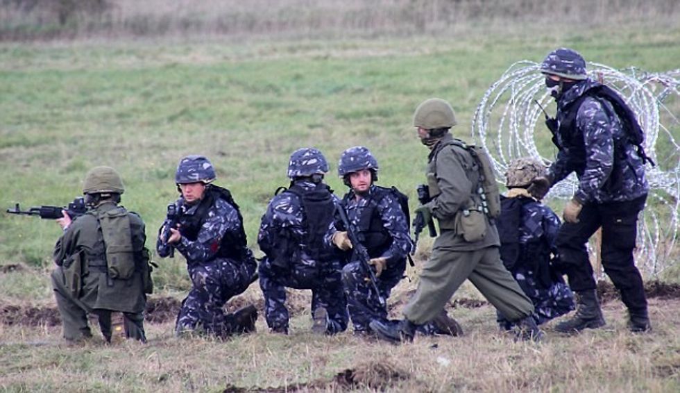 DPL778 : (Blue and Green soldiers). Civilian actors from Aspire wear blue uniforms to simulate the local Police Militia in Crimea, who wore blue uniforms and supported Moscow. Picture:- Bob Morrison/Defence Picture Library