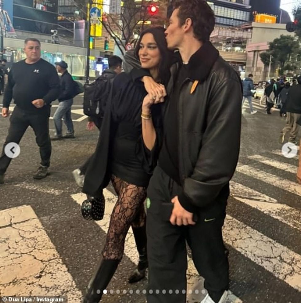 Dua Lipa cosied up to Callum Turner in Tokyo on Monday as they crossed a busy road in the city