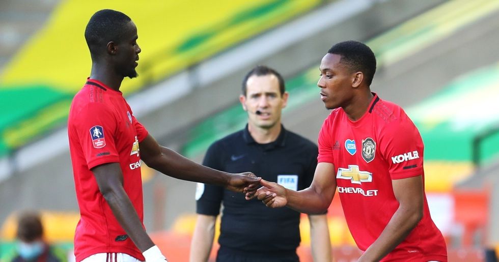 Eric Bailly shakes hands with substitute Anthony Martial