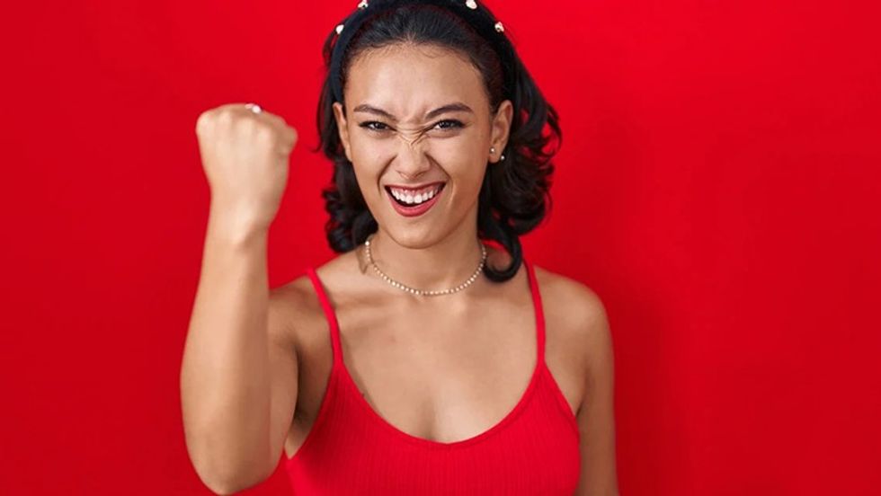 Eustress with Examples of Strong Woman with arm raised red background kraken 2347931