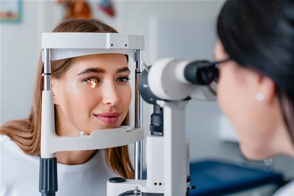 eye doctor with female patient during