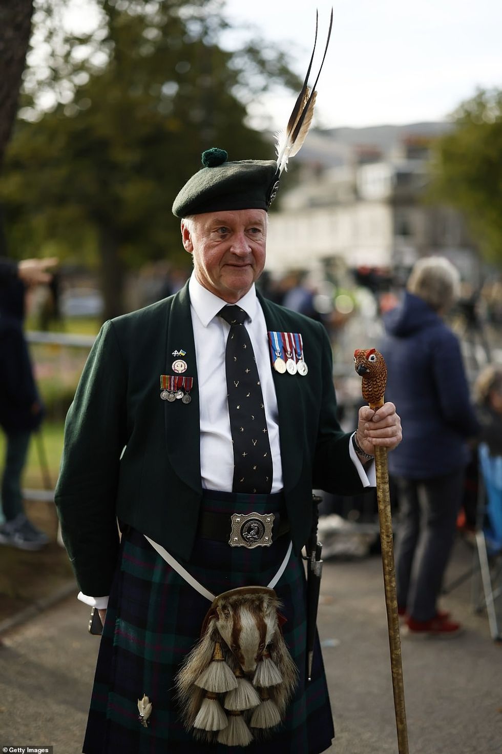 Families have been seen setting up picnic chairs and attaching union flags to barriers outside the village's Glenmuick Church