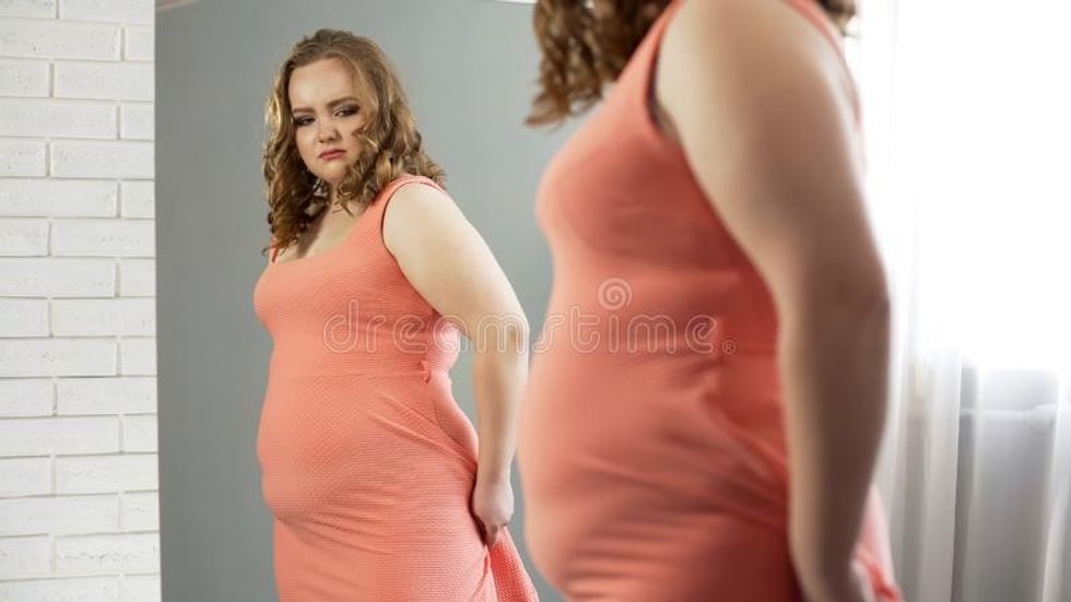 fat female looking mirror upset her appearance o