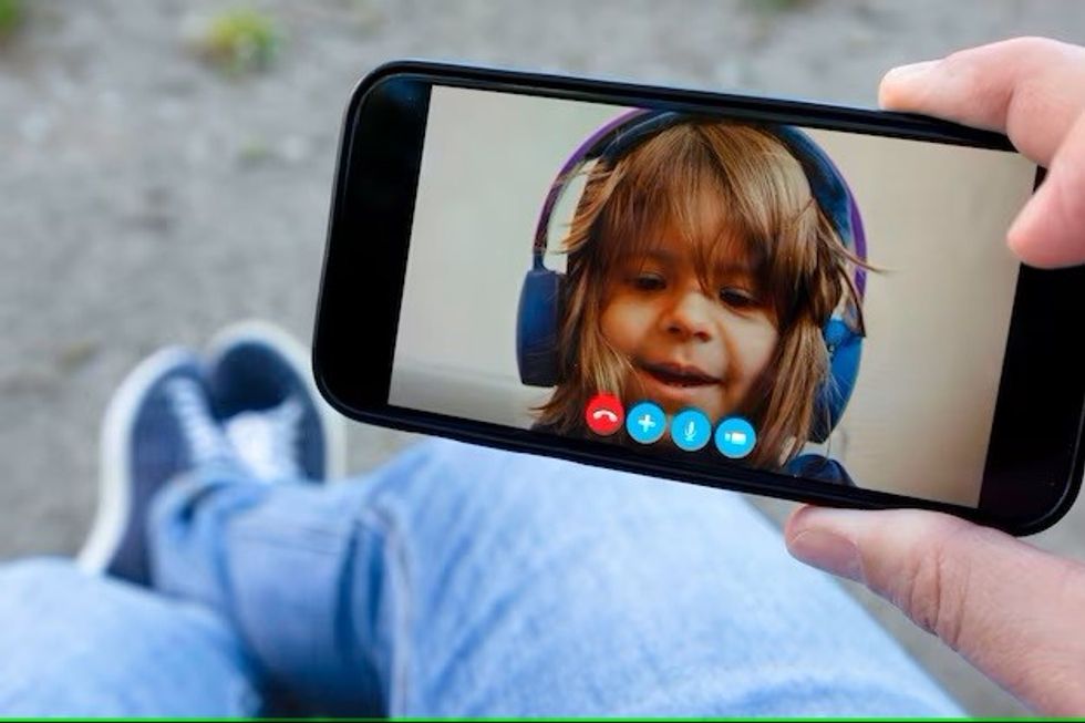 father daughter talking each other through video