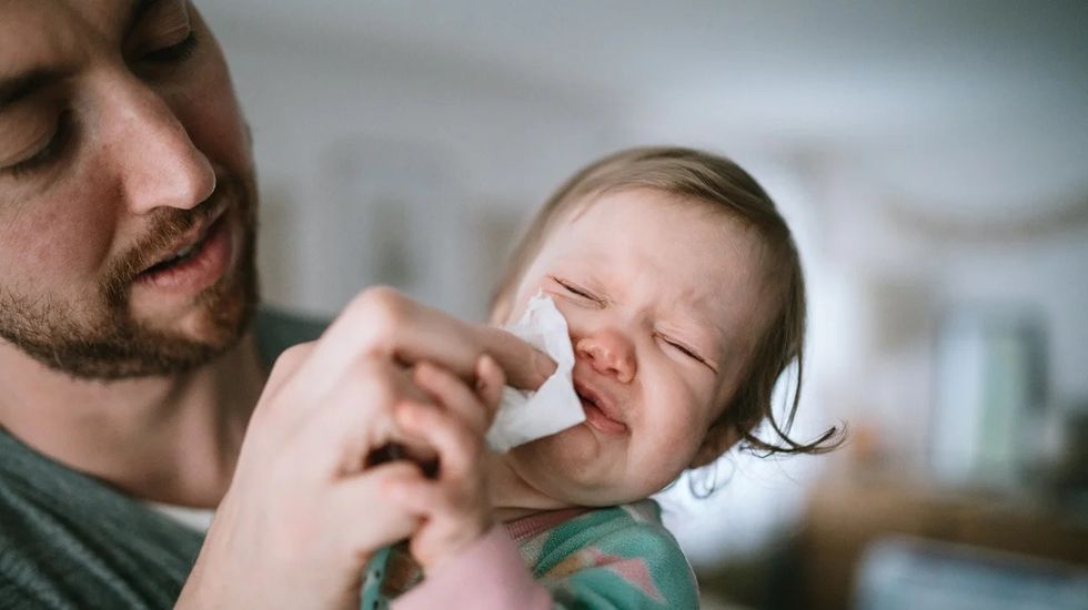 father helping sick baby header