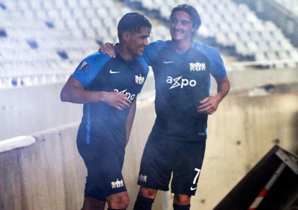 fc zurich player benjamin kololli celebrates europa league goal by jumping over barrier and misjudging the big drop