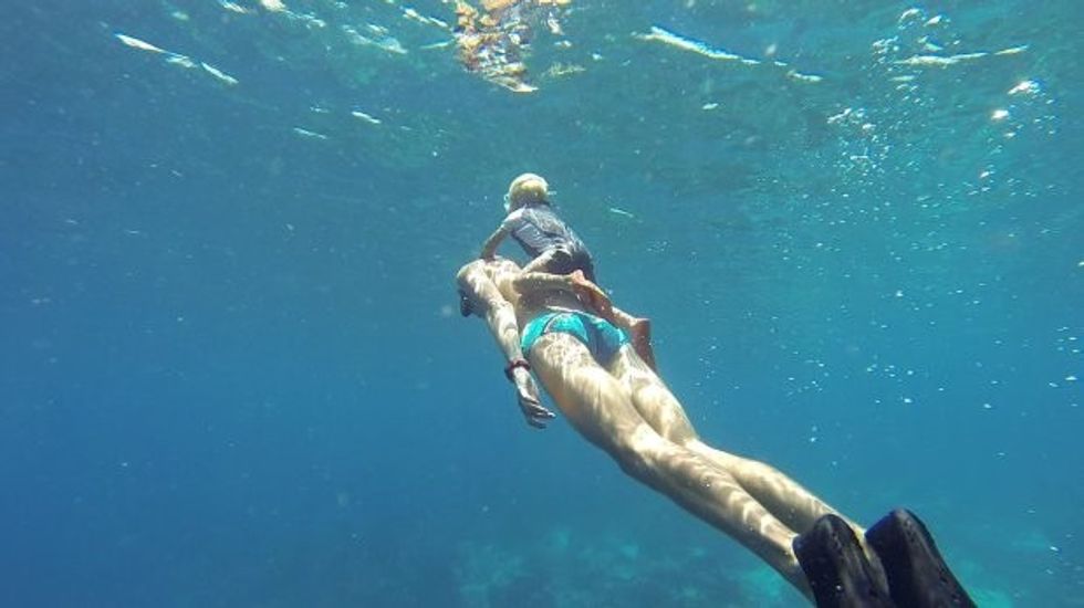 Fedor, aged two, freediving on his dad's back. STUNNING video footage what could be the worldís youngest freediver learning his trade without any air supply from the age of TWO. The video and pictures shows the young boy, who has been training since the age of two, hold onto his dadís back as he dives under the surface of the water before he emerges for air twenty seconds later. The incredible footage also shows the kid, called Fedor who is the son of a pro-freediver repeating the trick on his mumís back as she swims underwater and aged three, using a rope to pull himself deep underwater before rising back above the surface when he can no longer hold his breath. The video was taken by professional freediver Alexey Molchanov (29) from Moscow, Russia as he was in Dahab, Blue Hole, Egypt. It shows three-year-old Fedor Afonasiev being taught how to freedive by his parents, who are friends of Alexeyís and instructors in his Freediving Federation education agency.