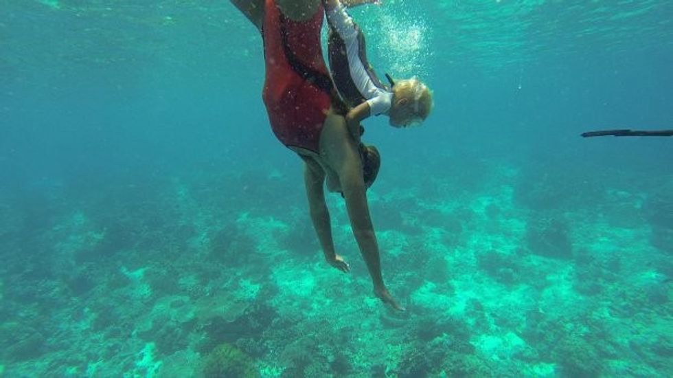 Fedor, aged two, freediving on his mum's back. STUNNING video footage what could be the worldís youngest freediver learning his trade without any air supply from the age of TWO. The video and pictures shows the young boy, who has been training since the age of two, hold onto his dadís back as he dives under the surface of the water before he emerges for air twenty seconds later. The incredible footage also shows the kid, called Fedor who is the son of a pro-freediver repeating the trick on his mumís back as she swims underwater and aged three, using a rope to pull himself deep underwater before rising back above the surface when he can no longer hold his breath. The video was taken by professional freediver Alexey Molchanov (29) from Moscow, Russia as he was in Dahab, Blue Hole, Egypt. It shows three-year-old Fedor Afonasiev being taught how to freedive by his parents, who are friends of Alexeyís and instructors in his Freediving Federation education agency.