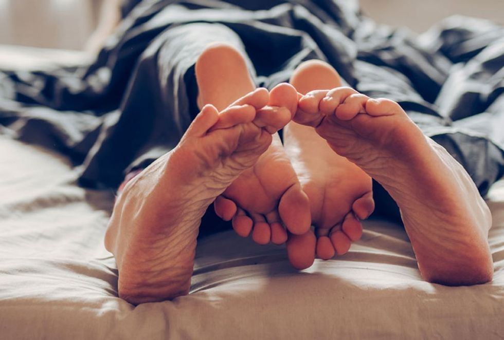 feet couple in bed