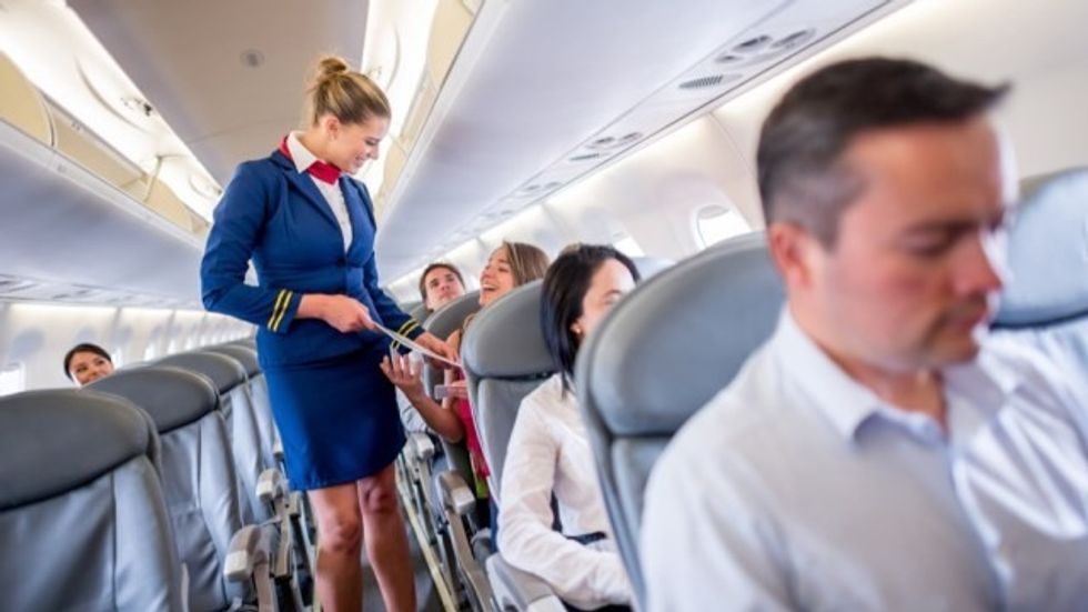 Flight Attendant in Aisle