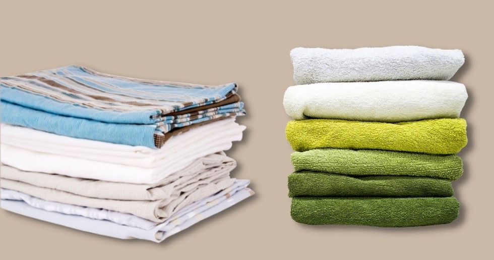 folded sheets and towels against brown background