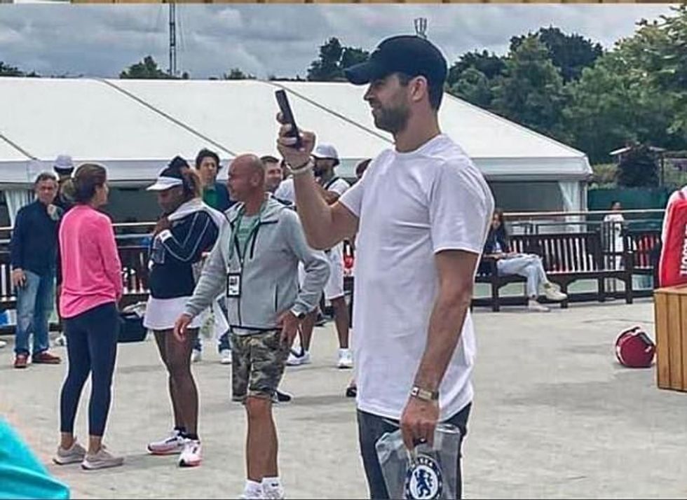 Gerard Pique was spotted in London carrying a number of Chelsea merchandise bags