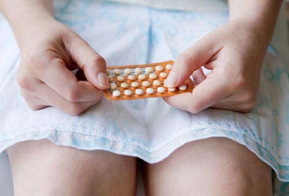 getty rm photo of woman holding birth control pills