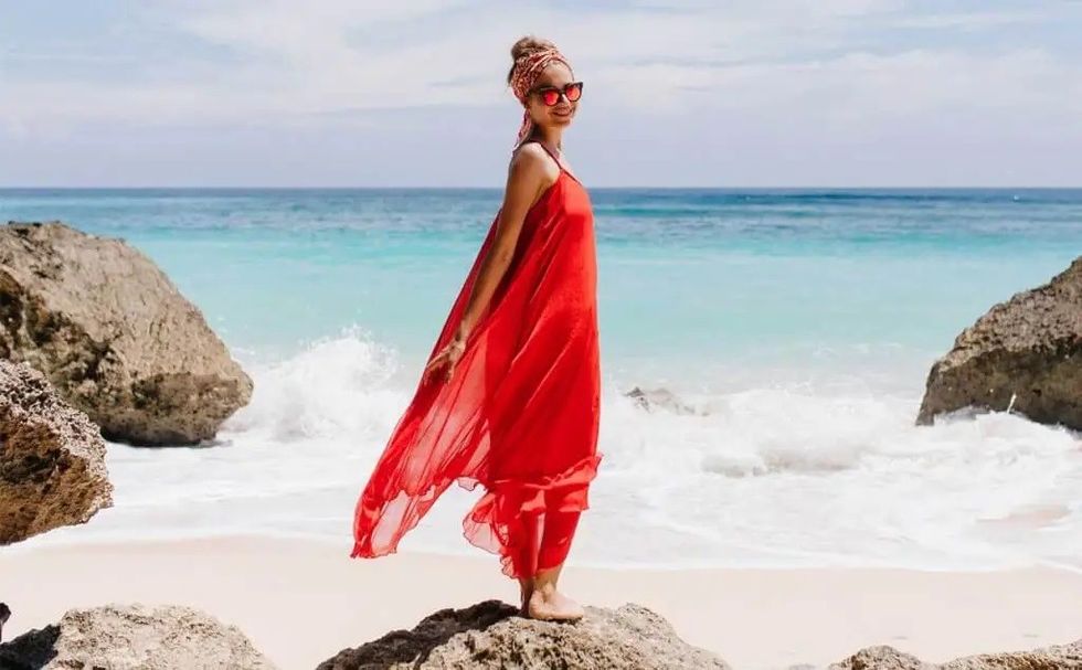 girl posing stone red dress sea