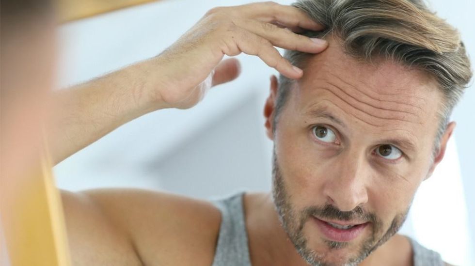 hair trends man looking at the mirror