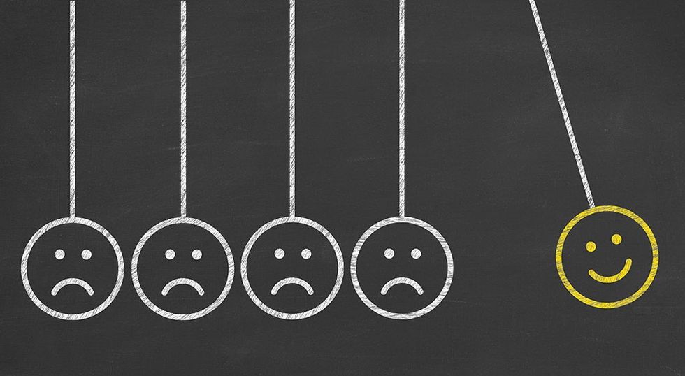 hand drawing unhappy and happy smileys on blackboard background