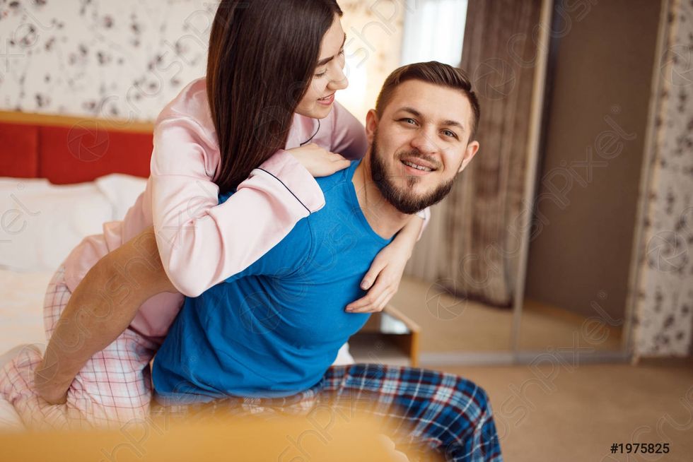 happy couple pajamas relaxing bed 1975825