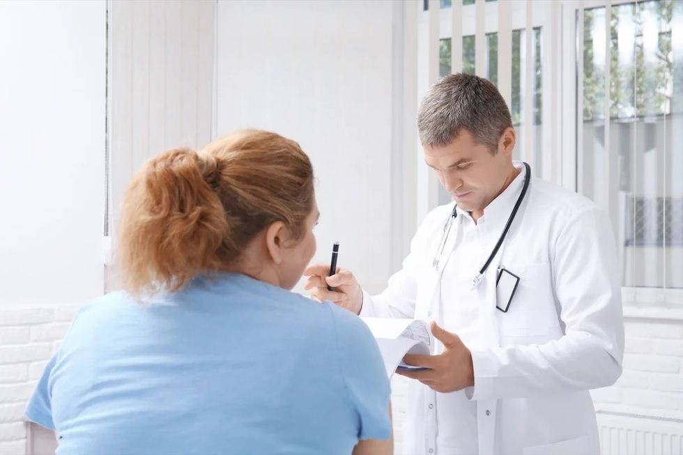 Heavyset woman talking to doctor