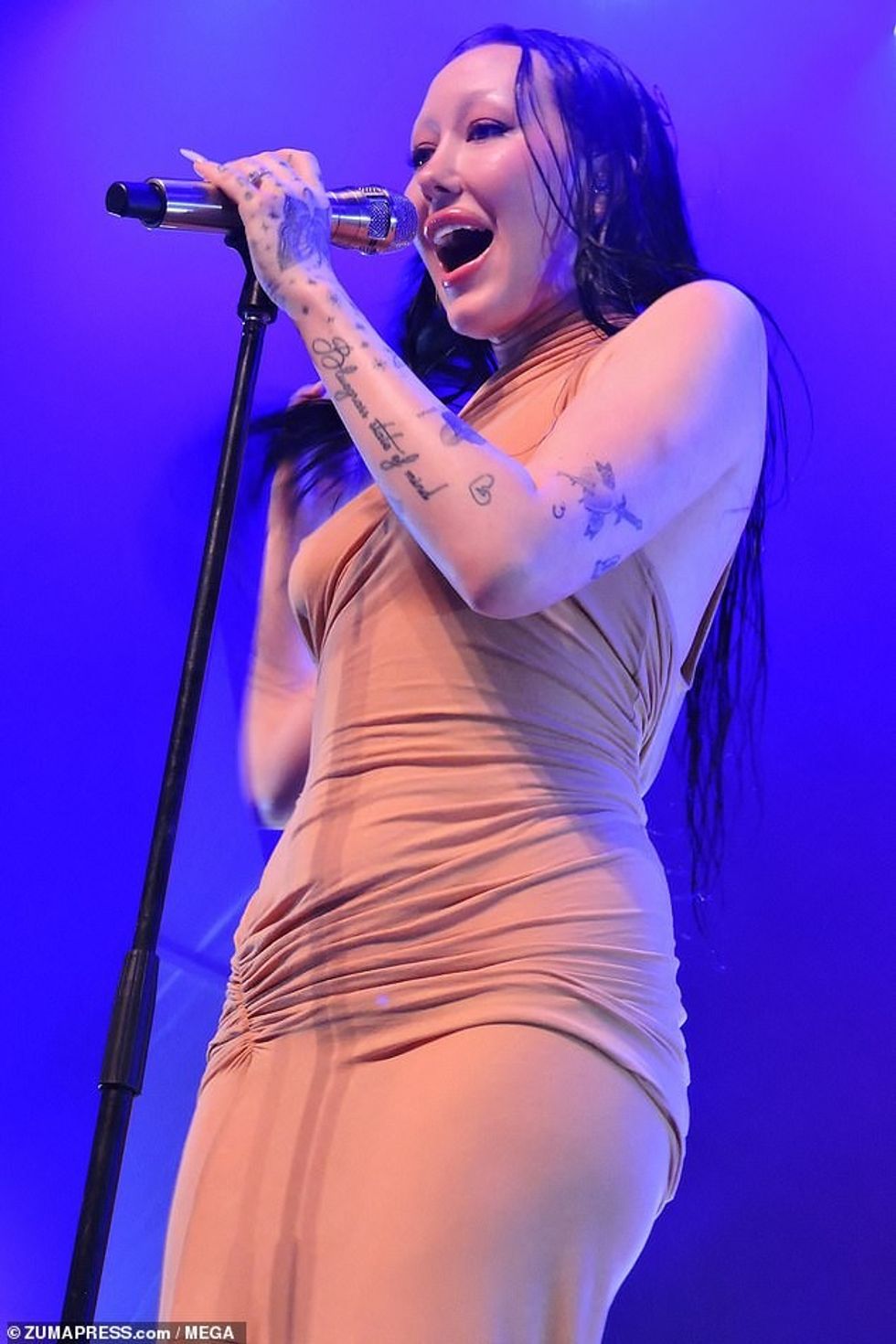 Her fresh manicure was on display as she caressed her body while preforming her latest hits