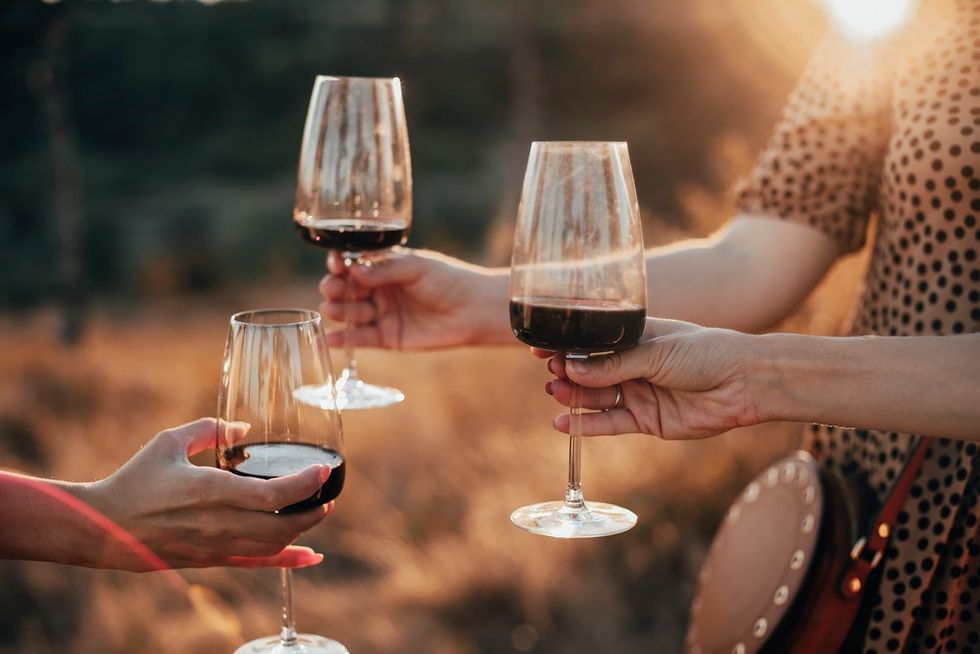 Holding wine glasses golden hour shutterstock
