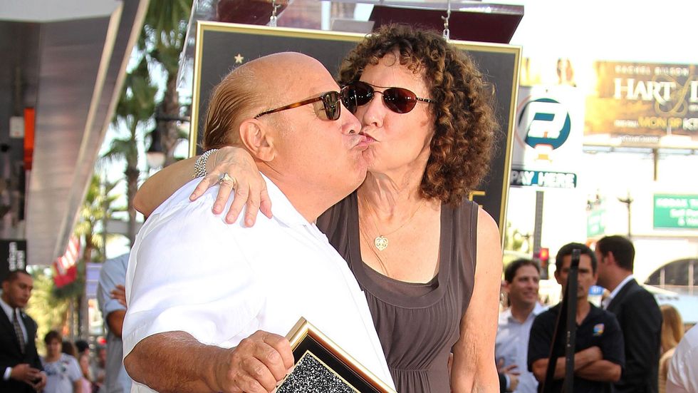 HOLLYWOOD, CA - AUGUST 18: Actor Danny DeVito (L) and actress Rhea Pearlman pose for photographers during the installation ceremony for his star on the Hollywood Walk of Fame on August 18, 2011 in Hollywood, California. (Photo by Frederick M. Brown/Getty Images)