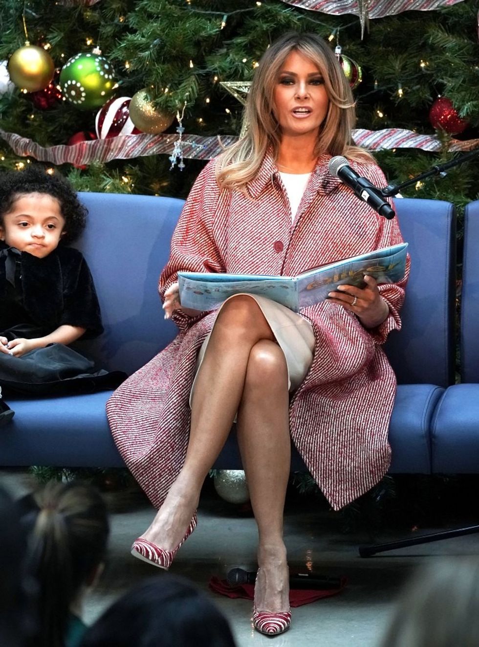 https://www.usmagazine.com/wp content/uploads/2018/12/melania trump striped outfit blonde