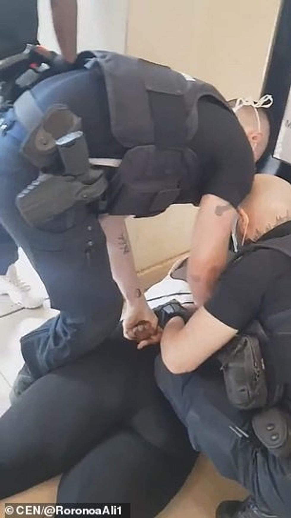 'I did not insult them, I did not hit them, I don't understand why they tackled me to the floor,' she said. 'Every time I see this footage, I have to cry. I see the images in my head.'