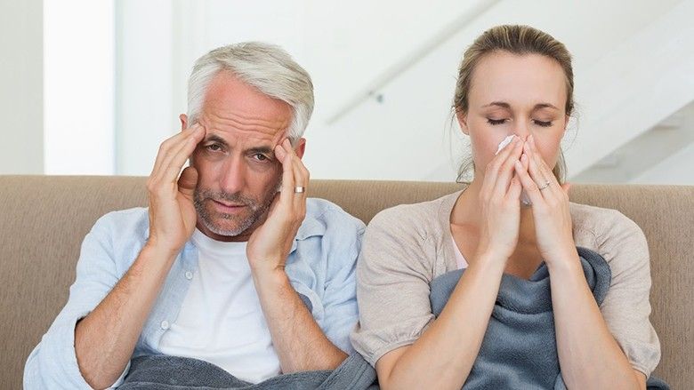 2016/11/Man-Woman-Couple-Sick-Cold-Flu-Couch-Headache-Sneezing.jpg