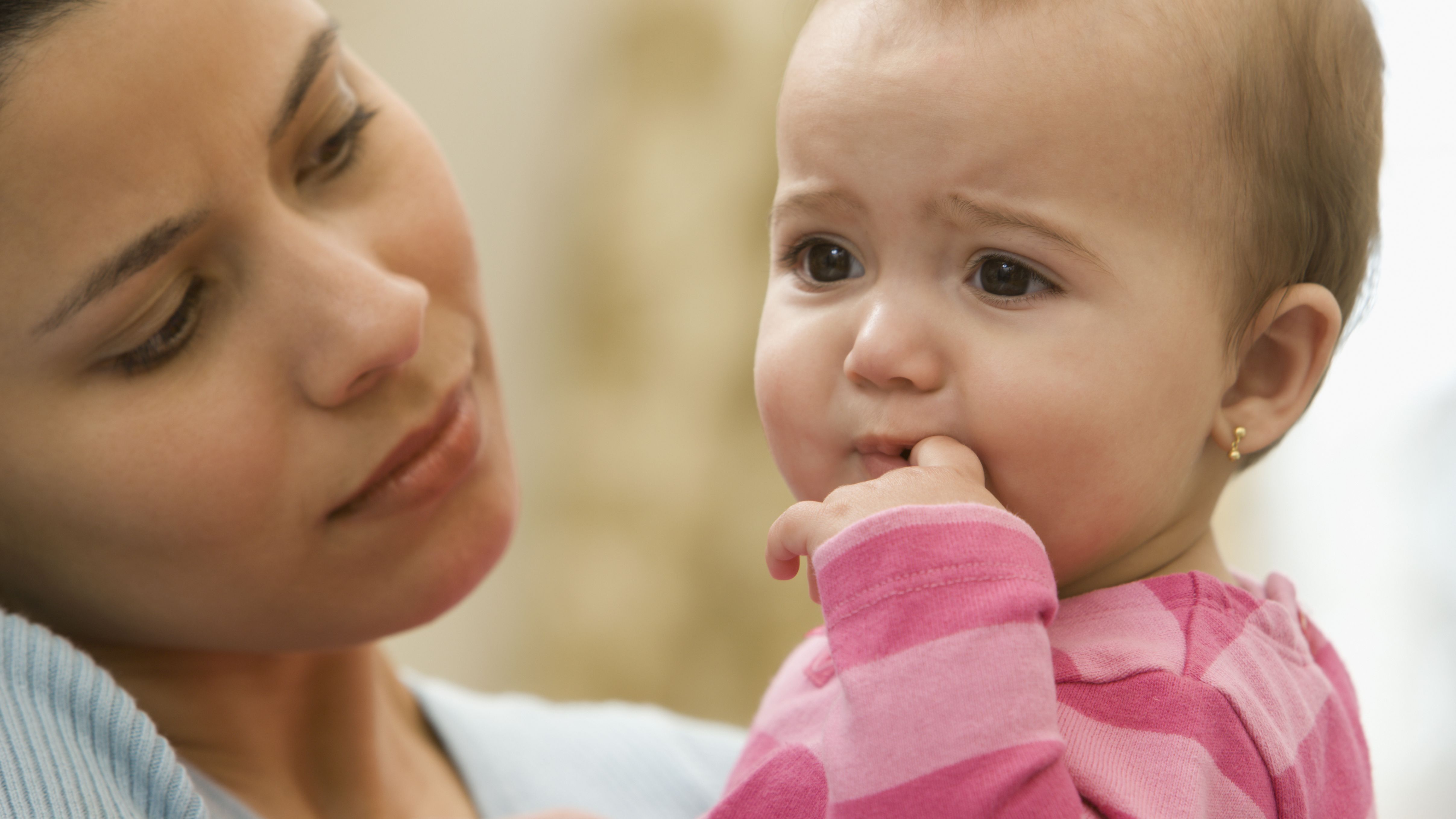 2017/07/hispanic-mother-holding-unhappy-baby-girl-scaled.jpg