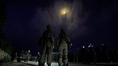 2021/07/israeli-soldiers-stand-under-flares-lebanon-border-e1626780094630.jpg