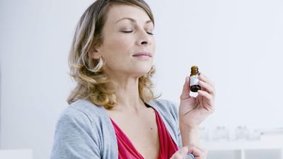 2022/07/Woman-smelling-essential-oil-extract.jpg