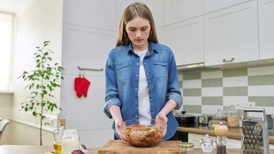 2022/11/young-woman-prepares-chicken-home-k.jpg